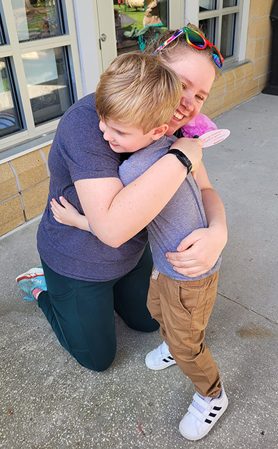 woman hugging a little boy
